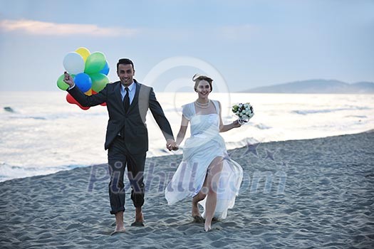 happy just married young couple celebrating and have fun at beautiful beach sunset happy just married young couple celebrating and have fun at beautiful beach sunset
