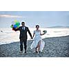 happy just married young couple celebrating and have fun at beautiful beach sunset