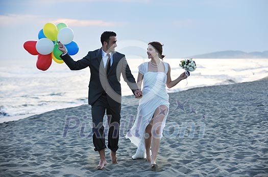 happy just married young couple celebrating and have fun at beautiful beach sunset happy just married young couple celebrating and have fun at beautiful beach sunset