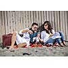 happy young couple enjoying  picnic on the beach and have good time on summer vacations