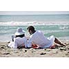 happy young couple enjoying  picnic on the beach and have good time on summer vacations