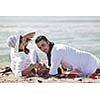 happy young couple enjoying  picnic on the beach and have good time on summer vacations