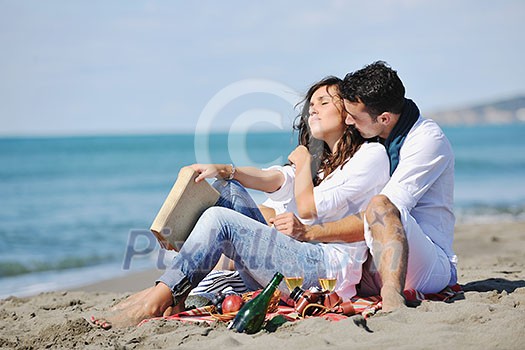 happy young couple enjoying picnic on the beach and have good time on summer vacations happy young couple enjoying picnic on the beach and have good time on summer vacations