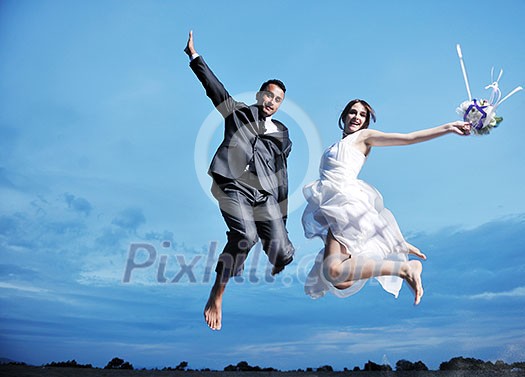 happy just married young couple celebrating and have fun at beautiful beach sunset happy just married young couple celebrating and have fun at beautiful beach sunset