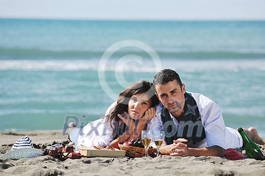 happy young couple enjoying picnic on the beach and have good time on summer vacations happy young couple enjoying picnic on the beach and have good time on summer vacations