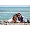 happy young couple enjoying  picnic on the beach and have good time on summer vacations