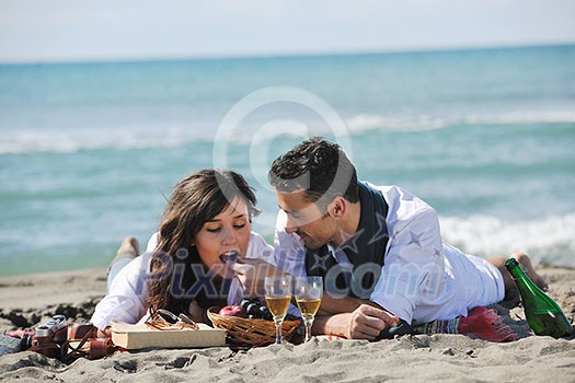 happy young couple enjoying picnic on the beach and have good time on summer vacations happy young couple enjoying picnic on the beach and have good time on summer vacations