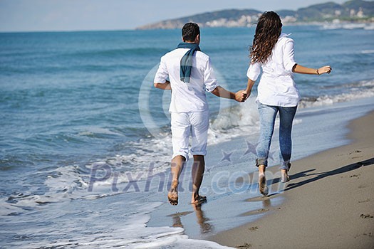 happy young couple in white clothing have romantic recreation and fun at beautiful beach on vacations happy young couple in white clothing have romantic recreation and fun at beautiful beach on vacations