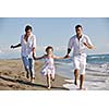 happy young family in white clothing have fun at vacations on beautiful beach 