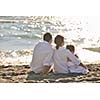 happy young family in white clothing have fun at vacations on beautiful beach 