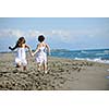 happy two little girls have fun and joy time at beautiful beach while running from joy 