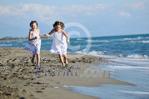 happy two little girls have fun and joy time at beautiful beach while running from joy happy two little girls have fun and joy time at beautiful beach while running from joy