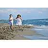 happy two little girls have fun and joy time at beautiful beach while running from joy 