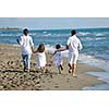 happy young family in white clothing have fun at vacations on beautiful beach 