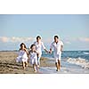 happy young family in white clothing have fun at vacations on beautiful beach 