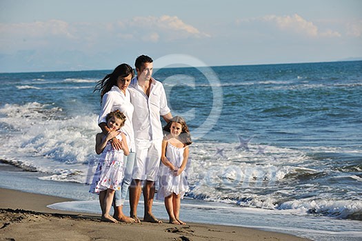 happy young family in white clothing have fun at vacations on beautiful beach happy young family in white clothing have fun at vacations on beautiful beach