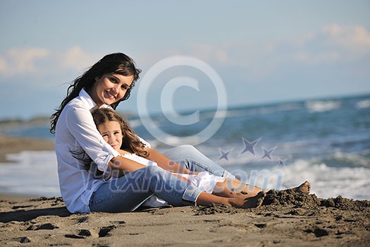 family portrait of young beautiful mom and daughter on beach family portrait of young beautiful mom and daughter on beach