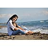 family portrait of young beautiful mom and daughter on beach