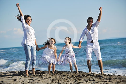 happy young family in white clothing have fun at vacations on beautiful beach happy young family in white clothing have fun at vacations on beautiful beach