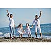 happy young family in white clothing have fun at vacations on beautiful beach 