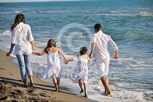 happy young family in white clothing have fun at vacations on beautiful beach happy young family in white clothing have fun at vacations on beautiful beach