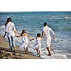 happy young family in white clothing have fun at vacations on beautiful beach 