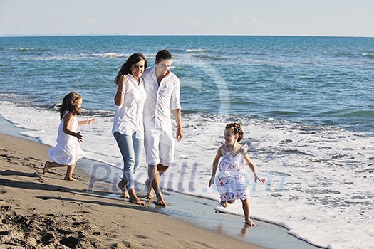 happy young family in white clothing have fun at vacations on beautiful beach happy young family in white clothing have fun at vacations on beautiful beach