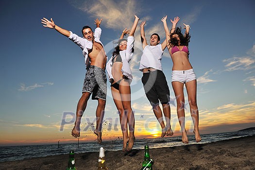 happy young friends group have fun and celebrate while jumping and running on the beach at the sunset happy young friends group have fun and celebrate while jumping and running on the beach at the sunset