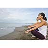 young couple people meditating yoga in lotus position at early morning on the beach