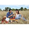 happy young couple enjoying  picnic on the countryside in the field  and have good time