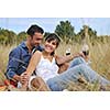 happy young couple enjoying  picnic on the countryside in the field  and have good time