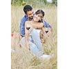 happy young couple enjoying  picnic on the countryside in the field  and have good time