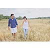 happy young couple enjoying  picnic on the countryside in the field  and have good time