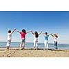 happy young people group have fun  run and jump  on beach beautiful sand  beach