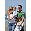 happy young family have fun and live healthy lifestyle on beach