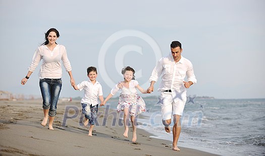 happy young family have fun and live healthy lifestyle on beach happy young family have fun and live healthy lifestyle on beach
