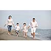 happy young family have fun and live healthy lifestyle on beach