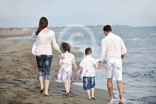 happy young family have fun and live healthy lifestyle on beach happy young family have fun and live healthy lifestyle on beach