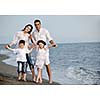happy young family have fun and live healthy lifestyle on beach
