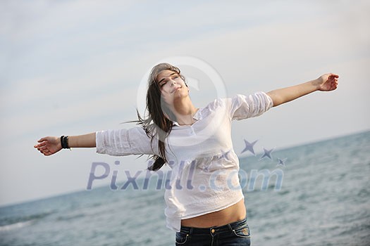 happy young woman relax on beautiful beach at fresh summer morning and enjoy first ray of sun happy young woman relax on beautiful beach at fresh summer morning and enjoy first ray of sun
