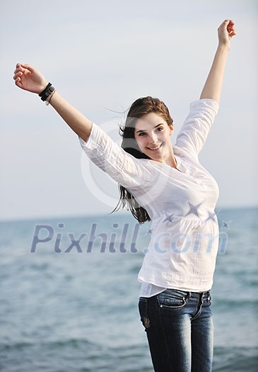 happy young woman relax on beautiful beach at fresh summer morning and enjoy first ray of sun happy young woman relax on beautiful beach at fresh summer morning and enjoy first ray of sun