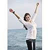 happy young woman relax on beautiful  beach at fresh summer morning and enjoy first ray of sun