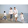 happy young family have fun and live healthy lifestyle on beach