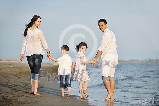 happy young family have fun on beach run and jump at sunset happy young family have fun on beach run and jump at sunset
