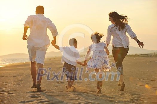 happy young family have fun on beach run and jump at sunset happy young family have fun on beach run and jump at sunset
