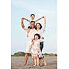 happy young family have fun and live healthy lifestyle on beach