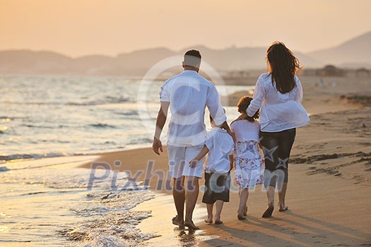 happy young family have fun on beach run and jump at sunset happy young family have fun on beach run and jump at sunset