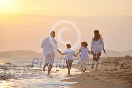 happy young family have fun and live healthy lifestyle on beach happy young family have fun and live healthy lifestyle on beach