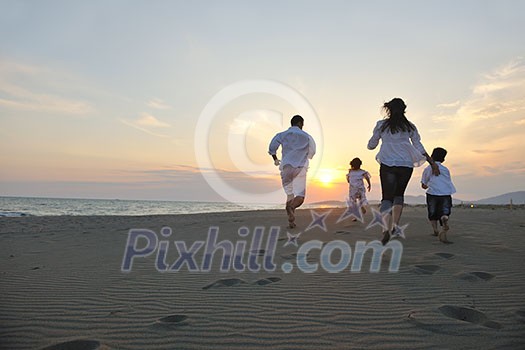 happy young family have fun on beach run and jump at sunset happy young family have fun on beach run and jump at sunset