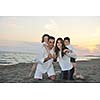 happy young family have fun and live healthy lifestyle on beach